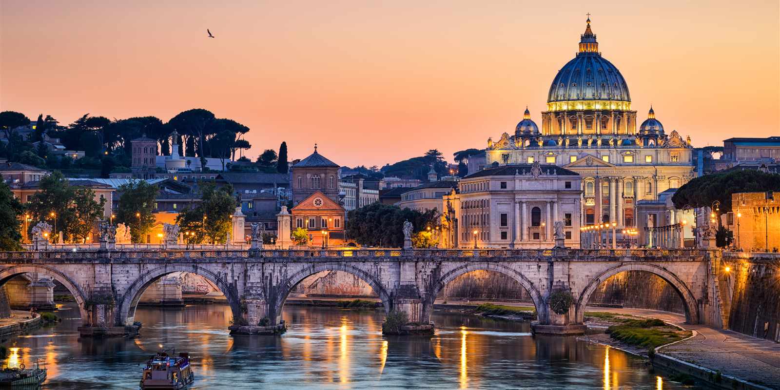 Florence skyline at sunset with the Arno River, arched stone bridge, and the Duomo's terracotta dome rising above warm golden rooftops